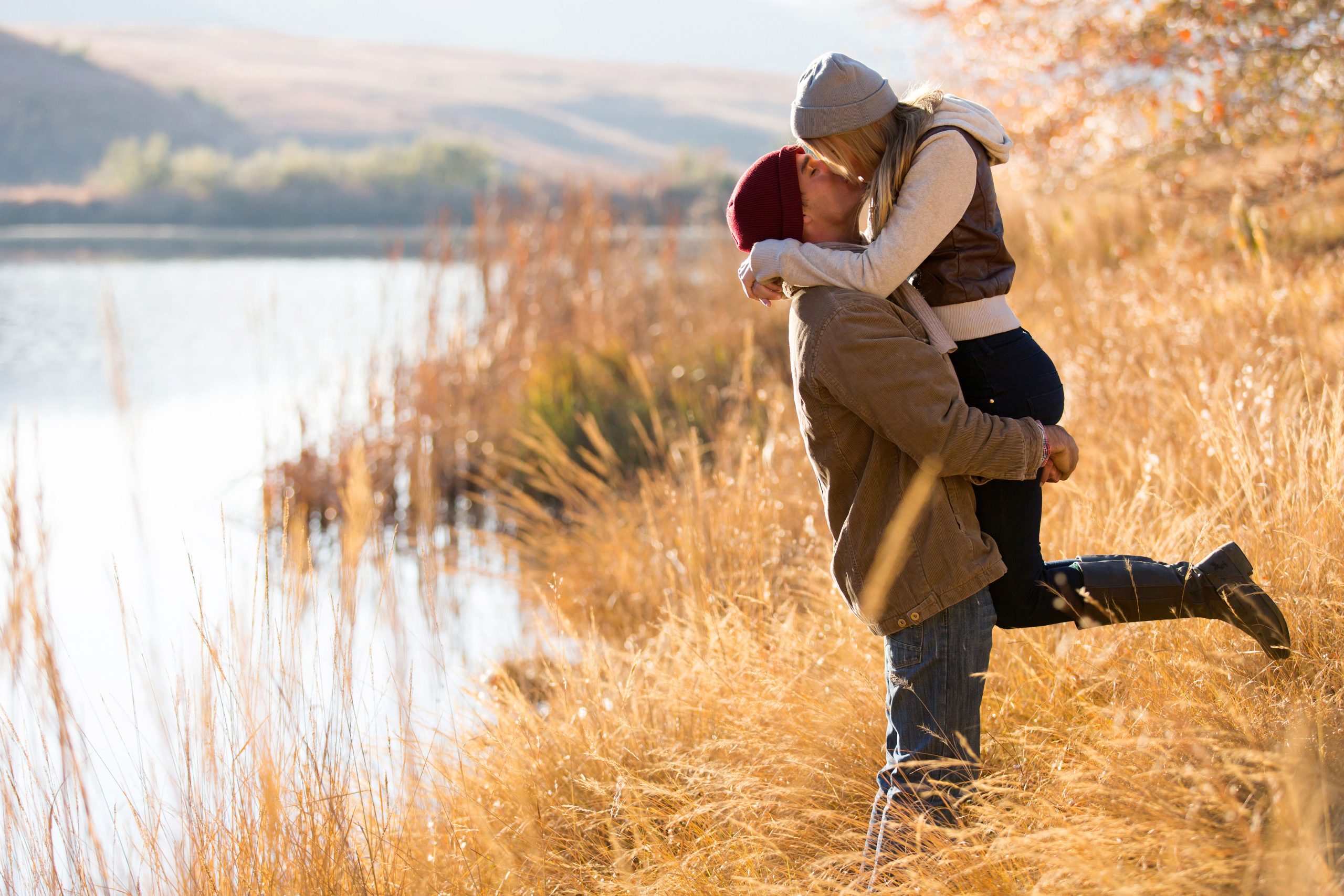 Confident man lifting woman
